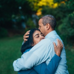 man hugging woman near trees