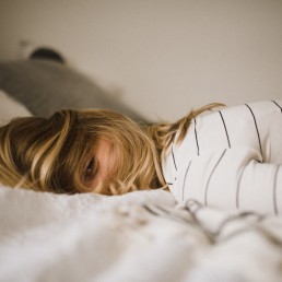 woman lying on bed