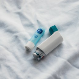 two toothbrushes sitting on top of a white sheet