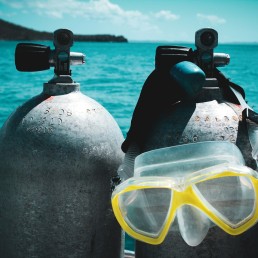 a pair of scuba goggles sitting on top of two buoys